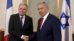 Israeli Prime Minister Benjamin Netanyahu shakes hands with French Foreign Minister Jean-Marc Ayrault