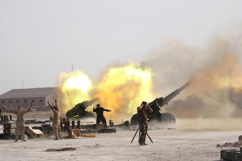 Iraqi security forces and Shi'ite fighters fire artillery towards Islamic State