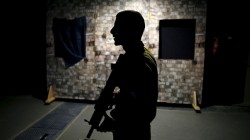 An Israeli soldier is silhouetted as he takes part in an open-fire scenario training in which soldiers respond with laser-firing rifles to a simulated Palestinian attack