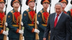 Israeli PM Netanyahu inspects honour guard during welcoming ceremony upon his arrival at Moscow's Vnukovo airport