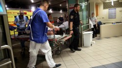 An injured man is taken into emergency room following a shooting attack that took place in the center of Tel Aviv