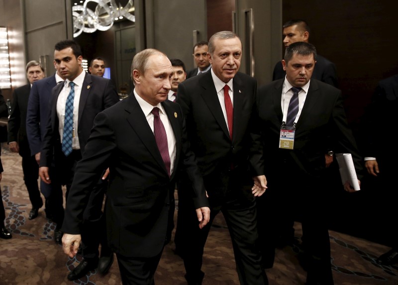 Turkey's President Tayyip Erdogan walks with his Russian counterpart Putin prior to their meeting at the Group of 20 (G20) leaders summit in the Mediterranean resort city of Antalya, Turkey