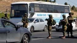 sraeli soldiers gather near the scene where a Palestinian fatally stabbed a 13-year-old girl inside her home, at the entrance to
