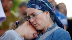 People mourn during the funeral of Israeli girl, Hallel Yaffa Ariel, 13, who was killed in a Palestinian stabbing attack in her home in the West Bank Jewish settlement of Kiryat Arba, at a cemetery in the West Bank city of Hebron