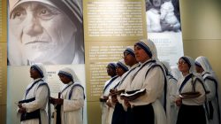 Members of Mother Teresa's order, the Missionaries of Charity, stand under a photograph before the unveiling of an official canonization portrait at the John Paul II National Shrine in Washington