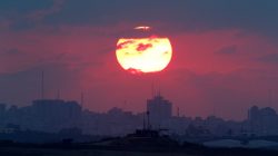 The sun sets over the Gaza Strip, as seen from the Israeli side