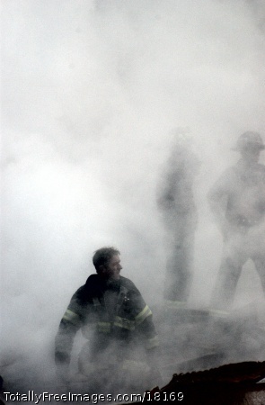 A firefighter emerges from the smoke and debris of the World Trade Center. The towers were destroyed in a Sept. 11 terrorist attack. U.S. Navy Photo by Photographer Mate 2nd class Jim Watson