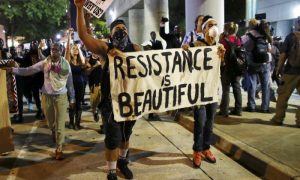 Protesters walk in the streets downtown during another night of protests over the police shooting of Keith Scott in Charlotte