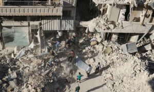 People dig in the rubble in an ongoing search for survivors at a site hit previously by an airstrike in the rebel-held Tariq al-Bab neighborhood of Aleppo,
