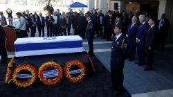 Former U.S. President Bill Clinton stands with Israeli President Reuven Rivlin and Knesset speaker Yuli Edelstein next to the flag-draped coffin of former Israeli President Shimon Peres, as he lies in state at the Knesset plaza,