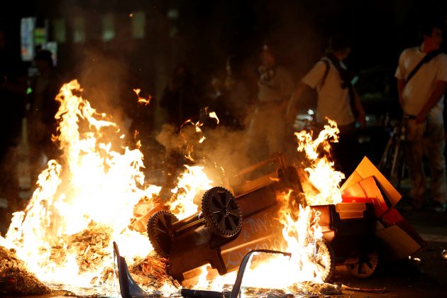 A pile of burning garbage set by demonstrators is seen on Broadway during a demonstration in Oakland, California, U.S. following the election of Donald Trump as President of the United