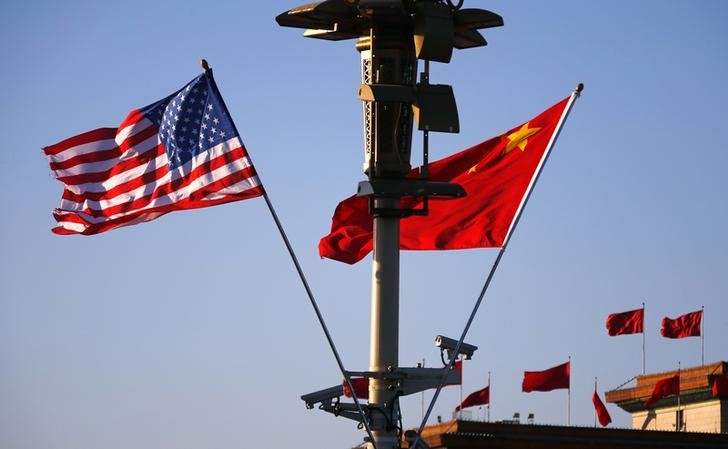 U.S. (L) and Chinese national flags flutter on a light post at the Tiananmen Square ahead of a welcoming ceremony for U.S. President Barack Obama, in Beijing,