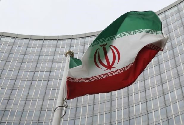 An Iranian flag flutters in front of the International Atomic Energy Agency (IAEA) headquarters in Vienna, Austria,