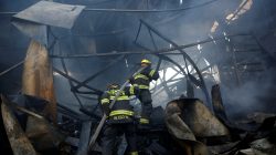 Firefighters work as a wildfire burns in the village of Beit Meir near Jerusalem