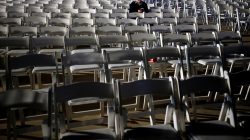 A student at the IAF academy sits within empty chairs waiting for the arrival of the first F-35s ordered by the Israeli air force to Israel at Nevatim in southern Israel