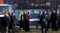 Rescue workers carry the body of a victim from the scene where police said a Palestinian rammed his truck into a group of Israeli soldiers on a popular promenade in Jerusalem