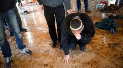 An Israeli settler touches the floor of a synagogue after it was evacuated during the second day of an operation by Israeli forces to evict the illegal outpost of Amona in the occupied West Bank
