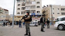 Israeli border police officers stand guard outside the building where Israeli security officers closed a Palestinian map office complying with an Israeli police order to close the office, in the Arab East Jerusalem neighbourhood of Beit Hanina March 14, 2017. REUTERS/Ammar Awad