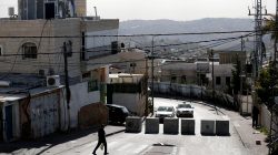 FILE PHOTO: A man walks next to a newly erected concrete barriers at the entrance to Jabel Mukaber, in an area of the West Bank that Israel captured in a 1967 war and annexed to the city of Jerusalem, the morning after a Palestinian rammed his truck into a group of Israeli soldiers on a popular promenade in Jerusalem January 9, 2017. REUTERS/Amir Cohen/File Photo
