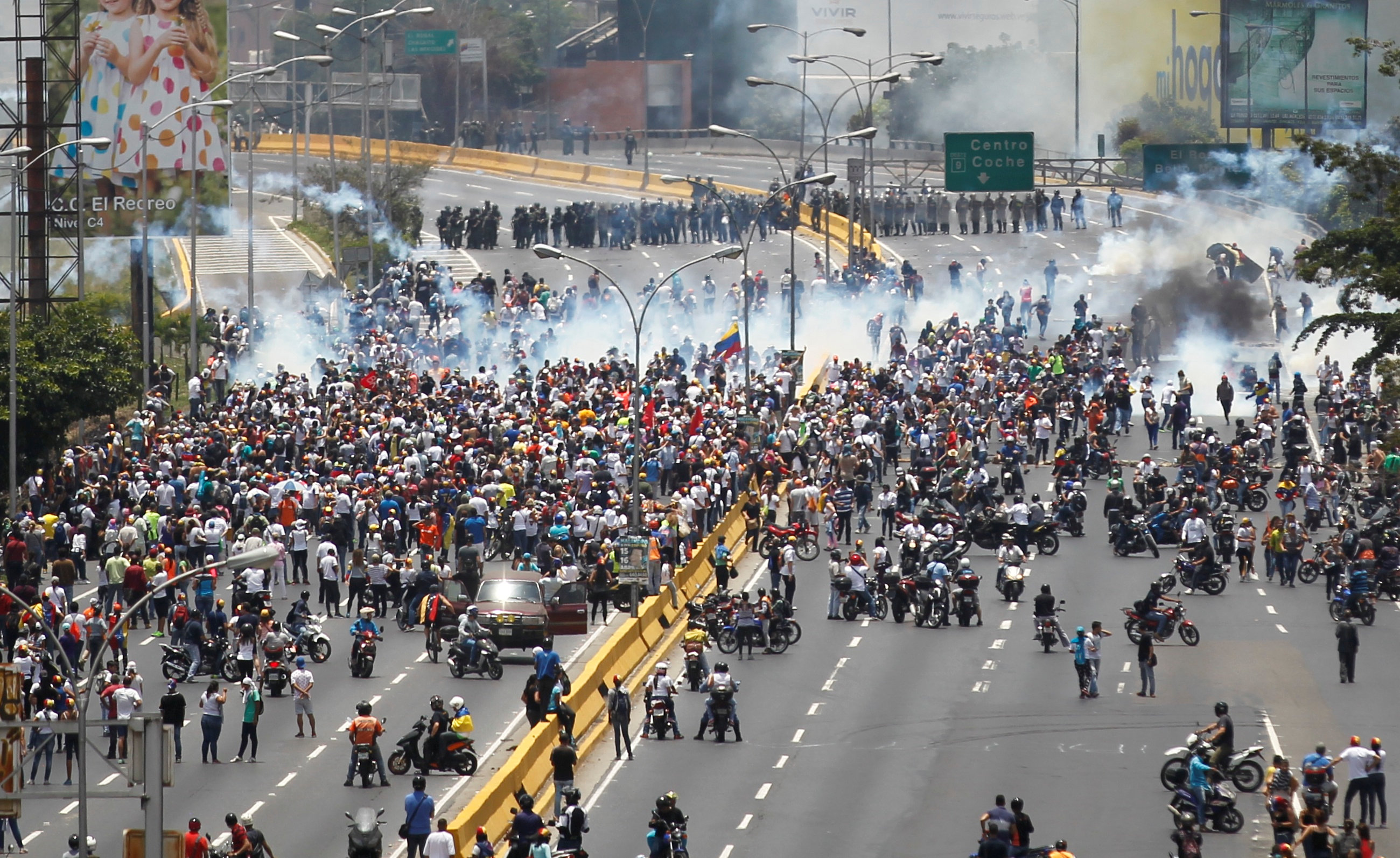 Demonstrators clash with riot police while ralling against Venezuela's President Nicolas Maduro's government in Caracas,