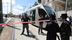 Israeli policemen block a road where the light train passes following a stabbing attack just outside Jerusalem's Old City, according to Israeli police April 14, 2017. REUTERS/Ammar Awad