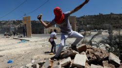 A Palestinian protester hurls stones towards Israeli troops during clashes in the West Bank village of Beita, near Nablus May 12, 2017. REUTERS/Mohamad Torokman