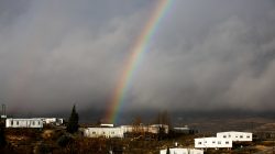 FILE PHOTO: A rainbow is seen over the Israeli settler outpost of Amona in the occupied West Bank January 31, 2017. REUTERS/Ronen Zvulun/File Photo