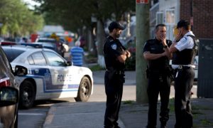 Police investigators talk outside the home of Amor Ftouhi, in Montreal, Quebec, Canada, June 21, 2017. Ftouhi has been identified as a suspect by the FBI in the stabbing of a police officer inside the main terminal of a small airport in Flint, Michigan. REUTERS/Christinne Muschi