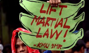 An anti martial law protestor hold a placard while protesting during the special session on the extension of martial law at the House of Representatives in Quezon City, metro Manila, Philippines July 22, 2017. REUTERS/Dondi Tawatao