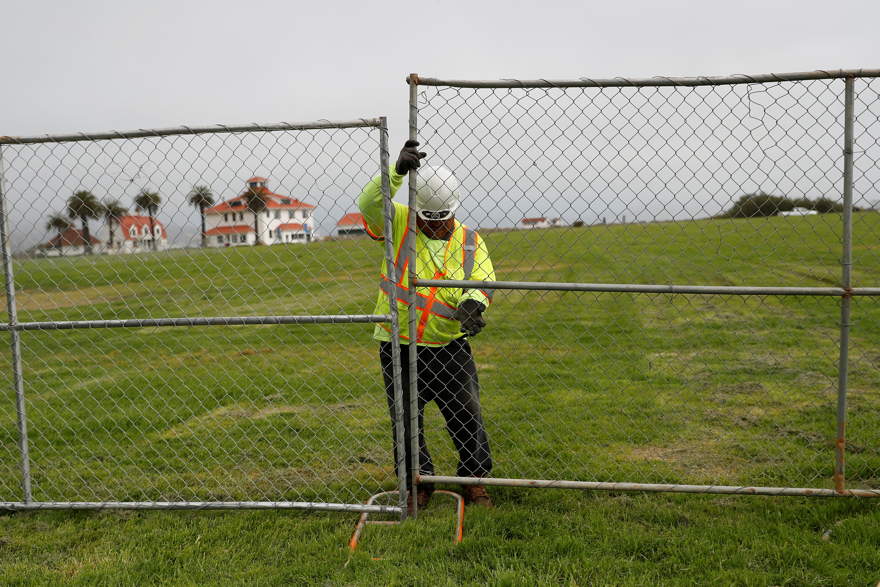 A worker installs a fence at Crissy Field in anticipation of Saturday's Patriot Prayer rally and counter demonstration in San Francisco, California, U.S. August 25, 2017. REUTERS/Stephen Lam