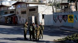 Israeli soldiers stand at a military camp in the West Bank city of Hebron October 17, 2017. REUTERS/Mussa Qawasma