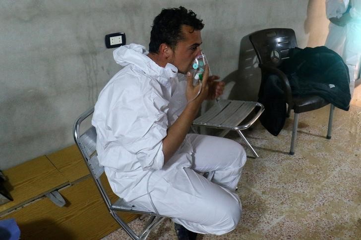 A man breathes through an oxygen mask, after what rescue workers described as a suspected gas attack in the town of Khan Sheikhoun in rebel-held Idlib, Syria April 4, 2017.