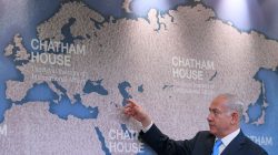 Israel's Prime Minister Benjamin Netanyahu gestures towards a world map as he attends a question and answer event on Israel's foreign policy at Chatham House in London, Britain, November 3, 2017.