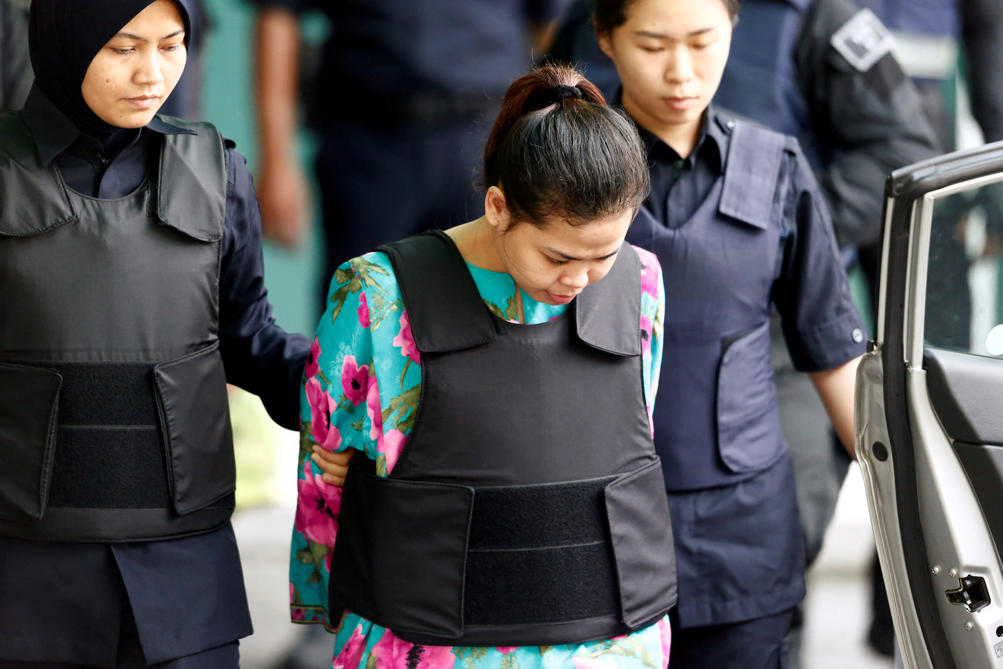 Indonesian Siti Aisyah who is on trial for the killing of Kim Jong Nam, the estranged half-brother of North Korea's leader, is escorted as she leaves at the Department of Chemistry in Petaling Jaya, near Kuala Lumpur, Malaysia