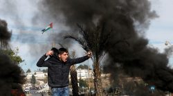A Palestinian demonstrator shouts during clashes with Israeli troops at a protest against U.S. President Donald Trump's decision to recognize Jerusalem as the capital of Israel, near the Jewish settlement of Beit El, near the West Bank city of Ramallah December 11, 2017.