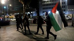 A protester carries a Palestinian flag at the end of a demonstration against U.S. President Donald Trump's decision to recognise Jerusalem as Israel's capital opposite to the American embassy in Tel Aviv, Israel December 12, 2017.