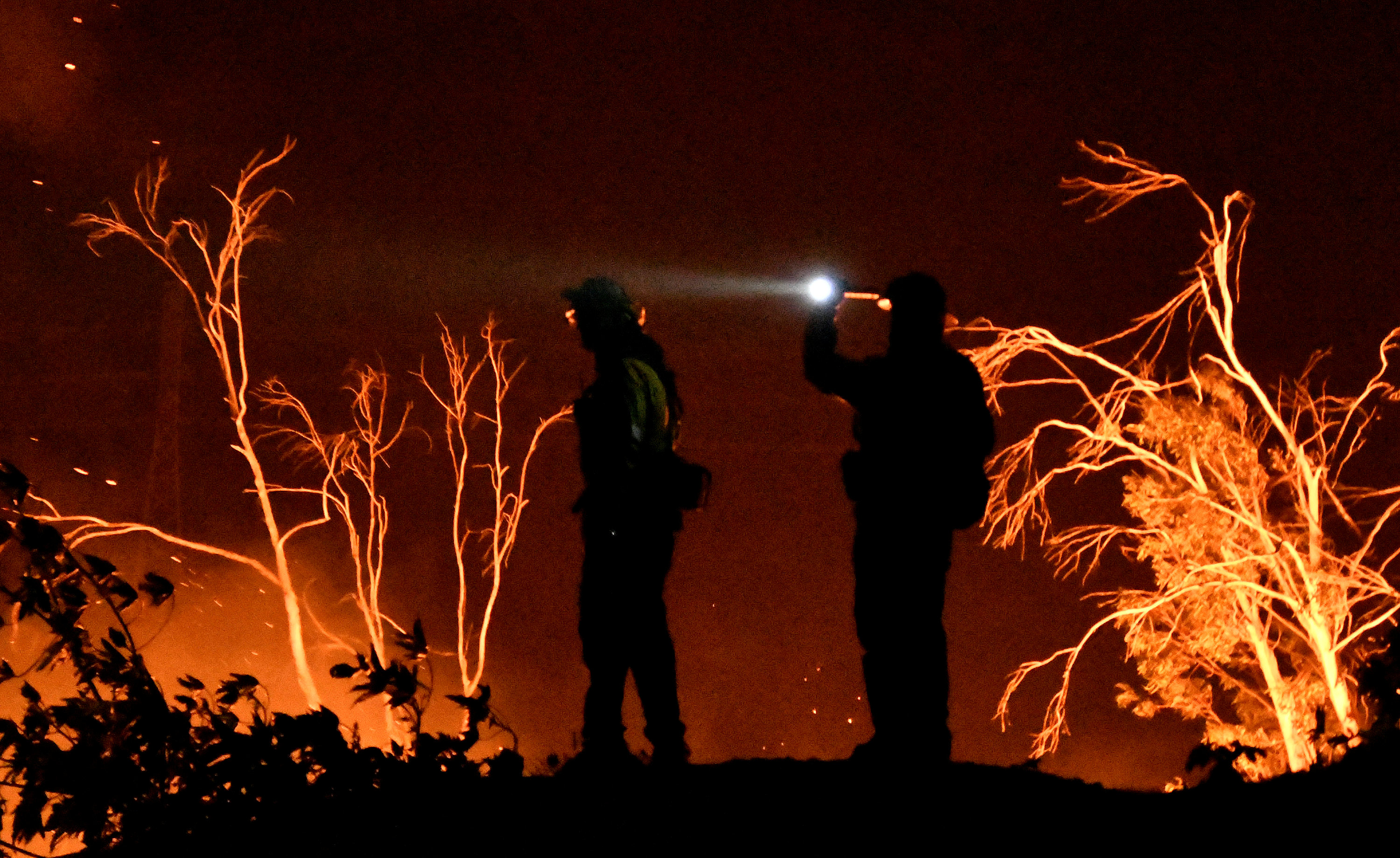 Firefighters keep watch on the Thomas wildfire in the hills and canyons outside Montecito, California, U.S., December 16, 2017.