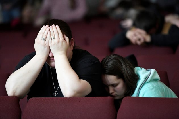 Tiffany Moreland and her daughter Emily Moreland attend a prayer vigil for students killed and injured after a 15-year-old boy opened fire with a handgun at Marshall County High School, at Life in Christ Church in Marion, Kentucky, U.S., January 23, 2018.