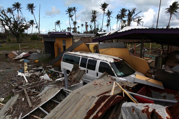 A car is partially buried under the remains of a building, after Hurricane Maria hit the island in September, in Humacao, Puerto Rico January 25, 2018.