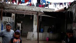 Palestinians stand at their house in the northern Gaza Strip February 12, 2018. REUTERS/Mohammed Salem