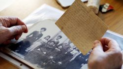 Holocaust survivor Betty Kazin Rosenbaum, 76, holds an old letter and a family photo during an interview in her house in Zichron Yaakov, Israel, April 10, 2018. Picture taken April 10, 2018. REUTERS/Nir Elias