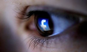 FILE PHOTO: A picture illustration shows a Facebook logo reflected in a person's eye, in Zenica, March 13, 2015. REUTERS/Dado Ruvic/Illustration/File Photo