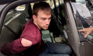 Travis Reinking, the suspect in a Waffle House shooting in Nashville, is under arrest by Metro Nashville Police Department in a wooded area in Antioch, Tennessee, U.S., April 23, 2018. Courtesy Metro Nashville Police Department/Handout via REUTERS