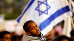 FILE PHOTO: A boy takes part in a protest against the Israeli government’s plan to deport African migrants, in Tel Aviv, Israel March 24, 2018. REUTERS/Corinna Kern/File Photo