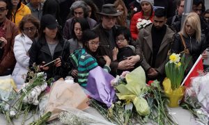 Mourners attend a makeshift memorial a day after a van struck multiple people along a major intersection in north Toronto, Ontario, Canada, April 24, 2018. REUTERS/Carlo Allegr