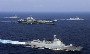 FILE PHOTO - China's aircraft carrier Liaoning (C) takes part in a military drill of Chinese People's Liberation Army (PLA) Navy in the western Pacific Ocean, April 18, 2018. Picture taken April 18, 2018. REUTERS/Stringer