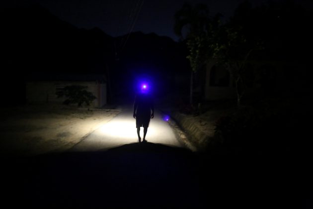 Jose Alvarez, 60, uses a head lamp while walking in the dark as the island's fragile power system is still reeling from the devastation wrought by Hurricane Maria eight months ago, in Jayuya, Puerto Rico May 10, 2018. REUTERS/Alvin Baez