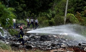 Firefighters work in the wreckage of a Boeing 737 plane that crashed in the agricultural area of Boyeros, around 20 km (12 miles) south of Havana, shortly after taking off from Havana's main airport in Cuba, May 18, 2018. REUTERS/Alexandre Meneghini