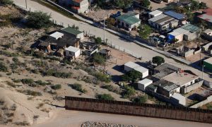 A U.S. border fence between Mexico and the United States ends in the back yard of homes in Juarez, Mexico next to Sunland Park, New Mexico, U.S. June 18, 2018. REUTERS/Mike Blake