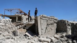 FILE PHOTO: Men inspect a damaged house in Busra al-Harir town, near Deraa, Syria March 13, 2018. REUTERS/Alaa al-Faqir/File Photo